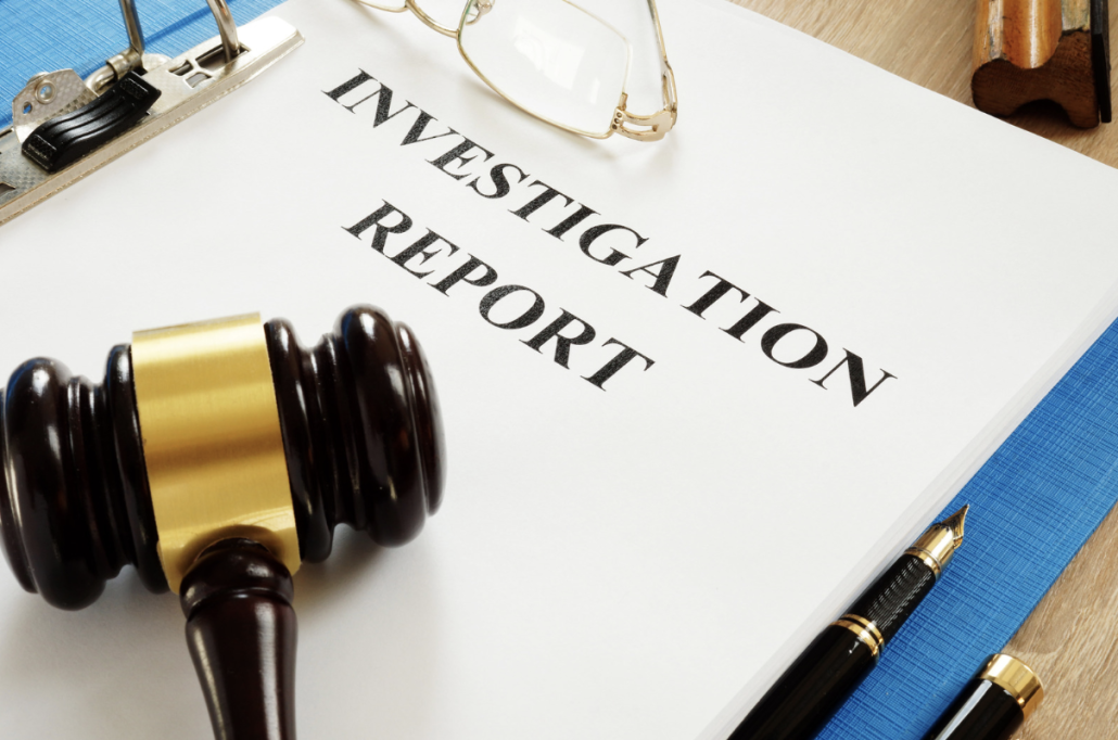 investigation report packet with gavel sitting on top